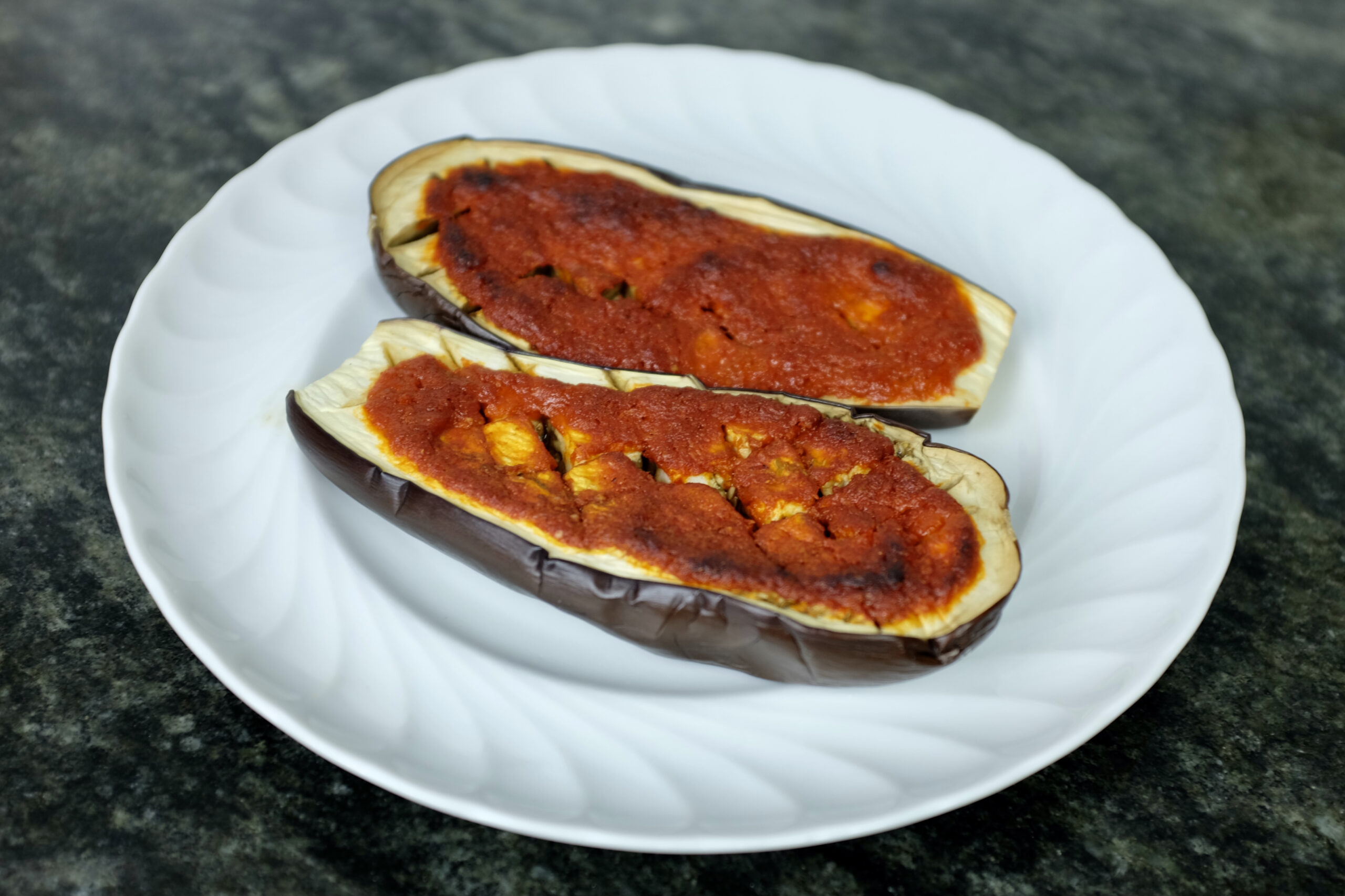 roasted aubergine halves with spicy paste of roasted red bell peppers