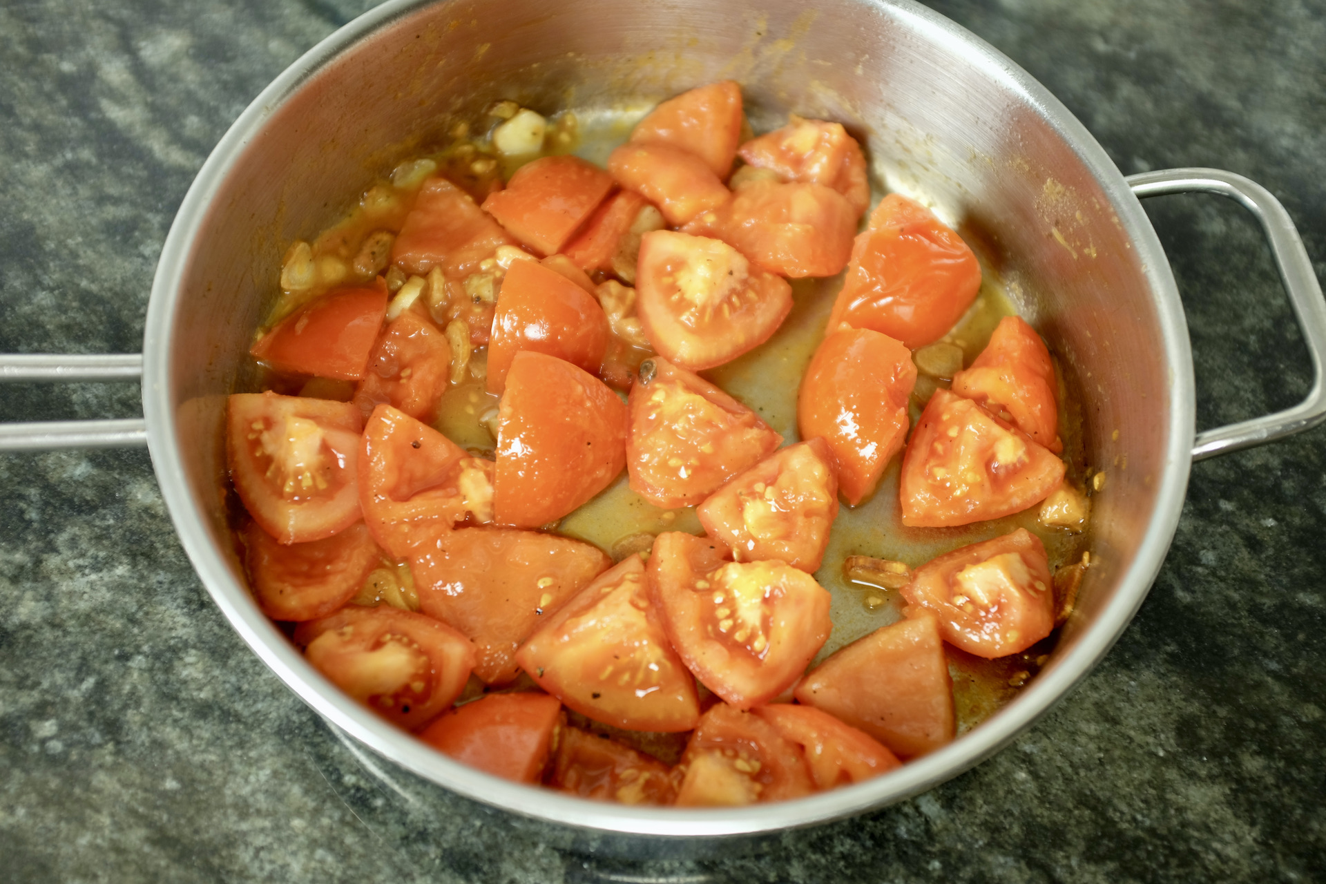 tomatoes gently roasted in olive oil with garlic slices