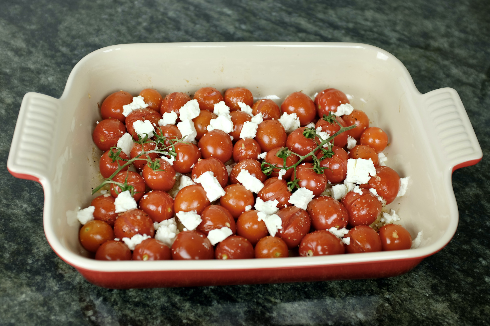 grape tomatoes on branch oven baked with garlic and feta cheese