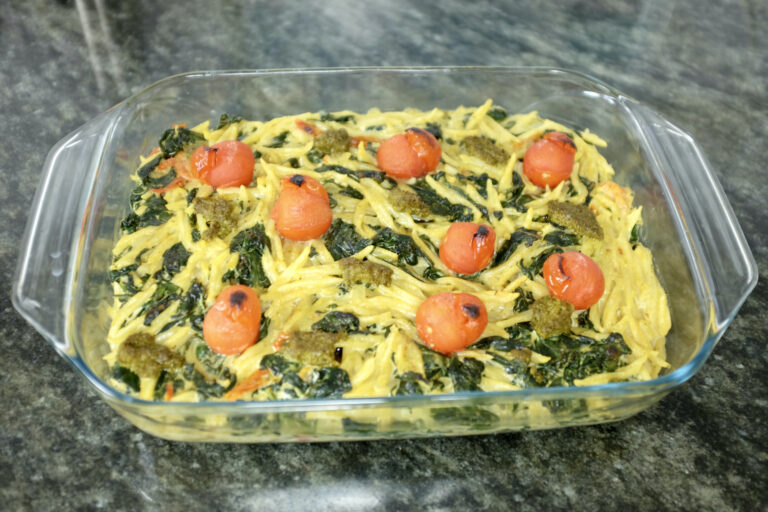 trofie pasta with grape tomatoes fresh spinach leaves pesto verde and mascarpone baked in the oven