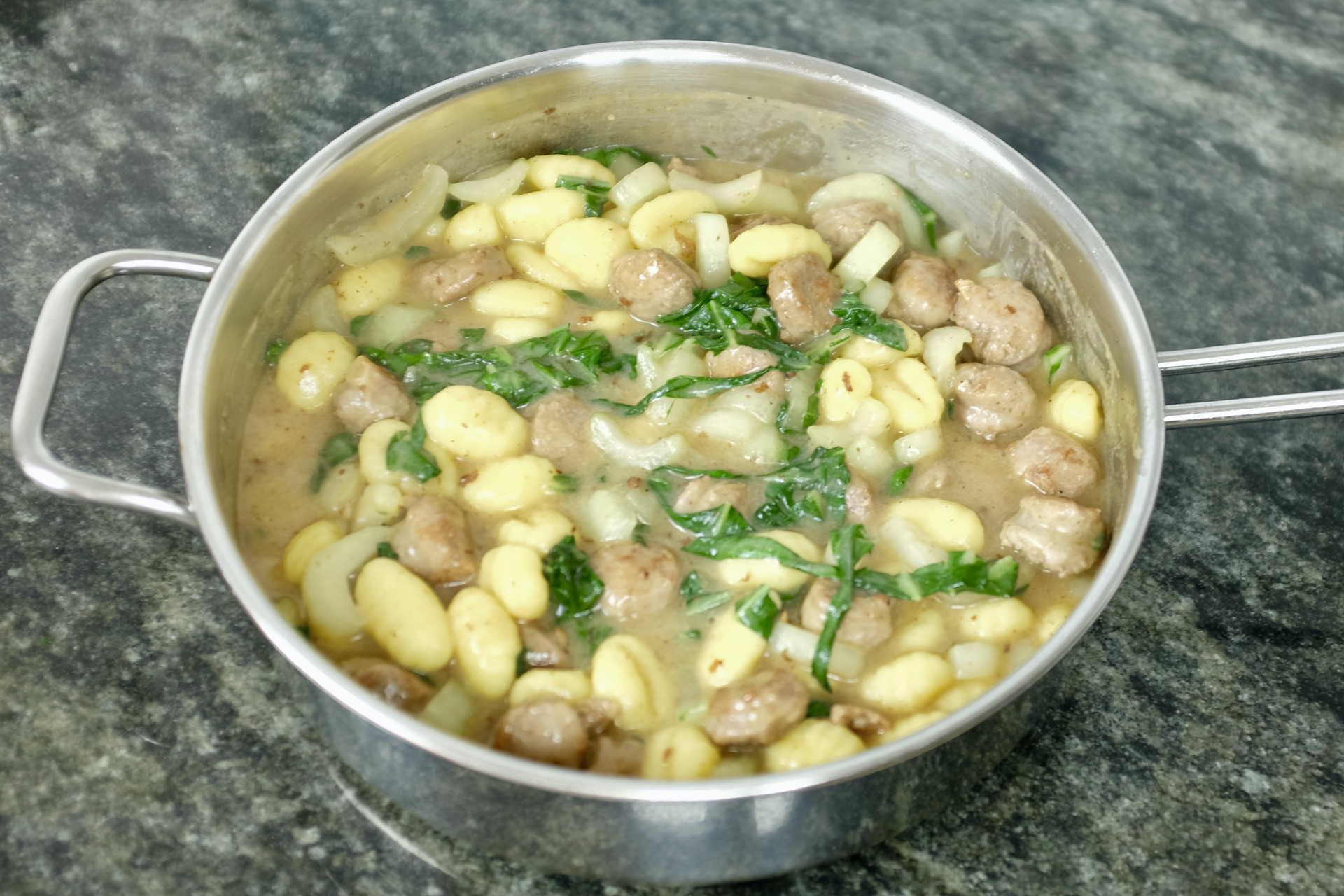 easy to make one pot gnocchi dish with bok choy and chopped fried sausages