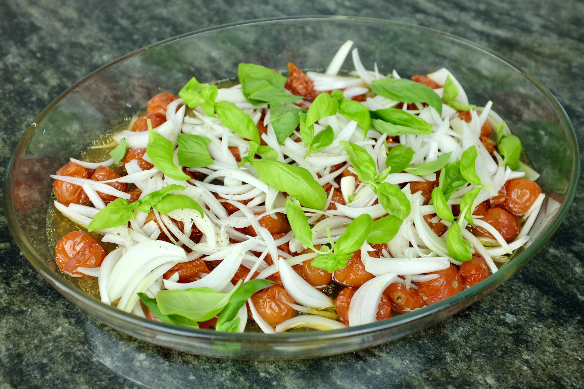 baked cherry tomatoes with sweet onion fresh basil leaves and apple cider vinegar dressing