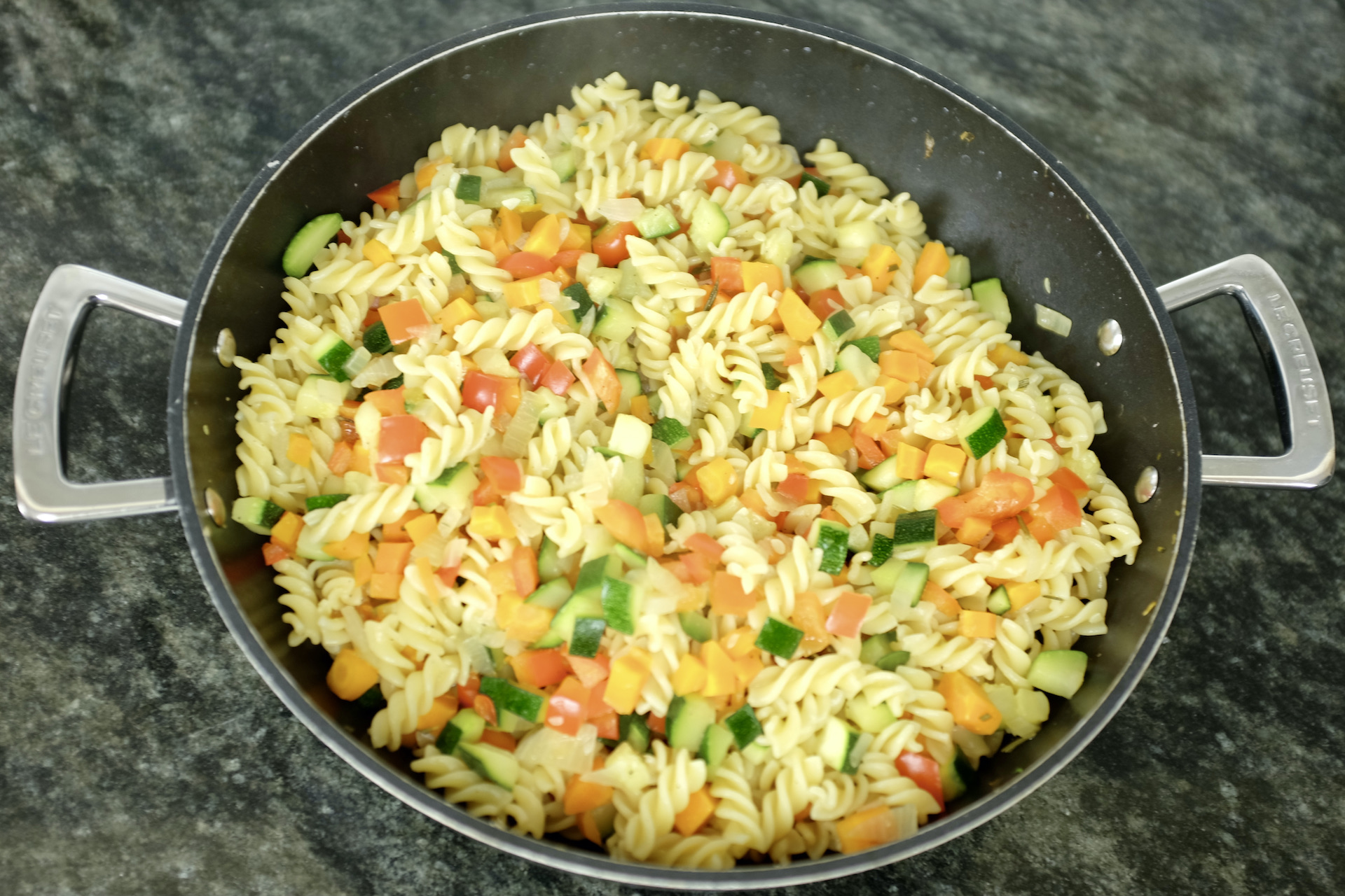 fusilli pasta with red pepper courgette carrot onion and fresh rosemary