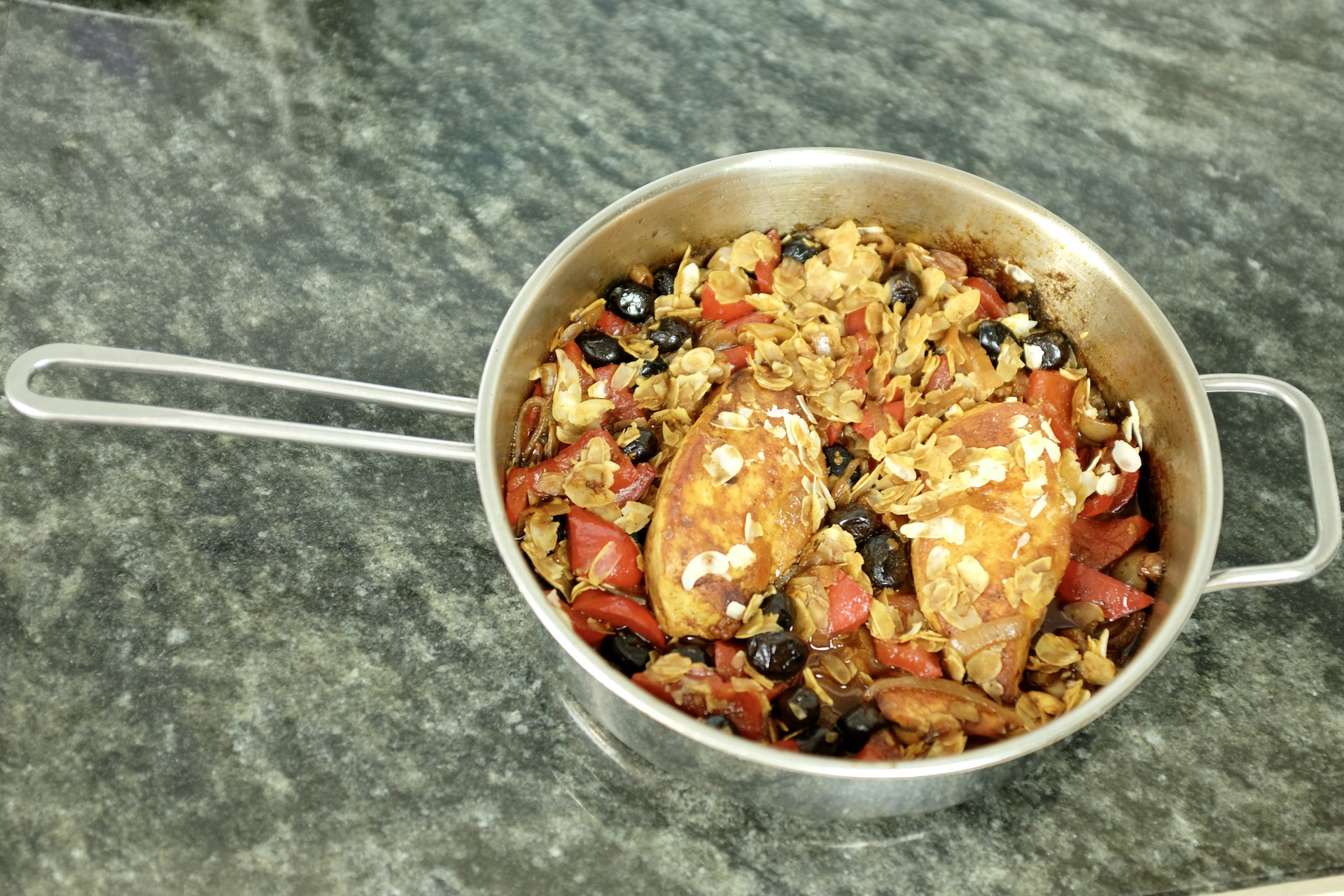 spanish chicken stew with red pepper black olives and roasted almond flakes