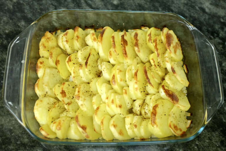 oven baked potatoes on a bed of onions