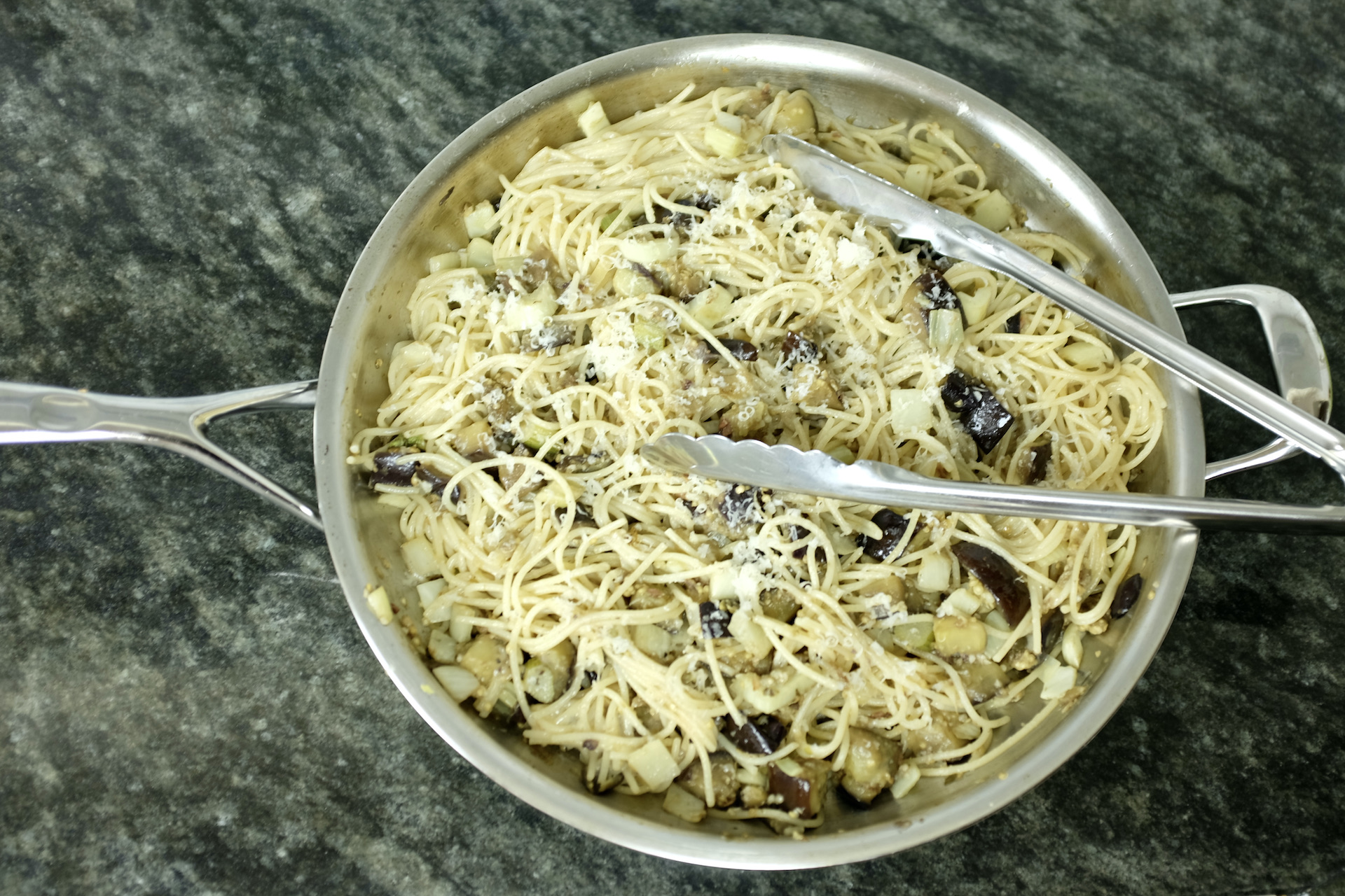 sicilian inspired spaghetti with aubergine capers anchovies and parmesan cheese