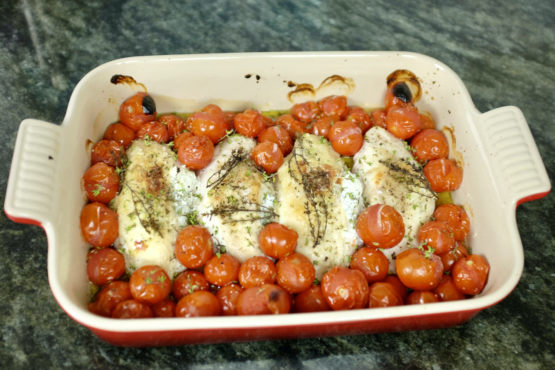 chicken with goat cheese fresh thyme and cherry tomatoes baked in the oven