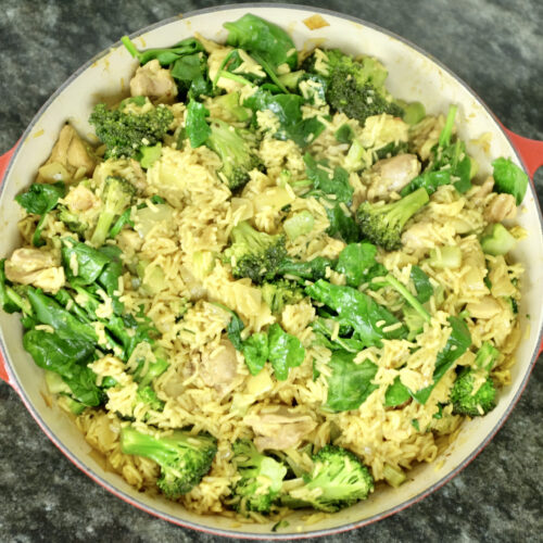 easy made one-pot chicken thigh fillets with curry basmati rice onion garlic broccoli and spinach