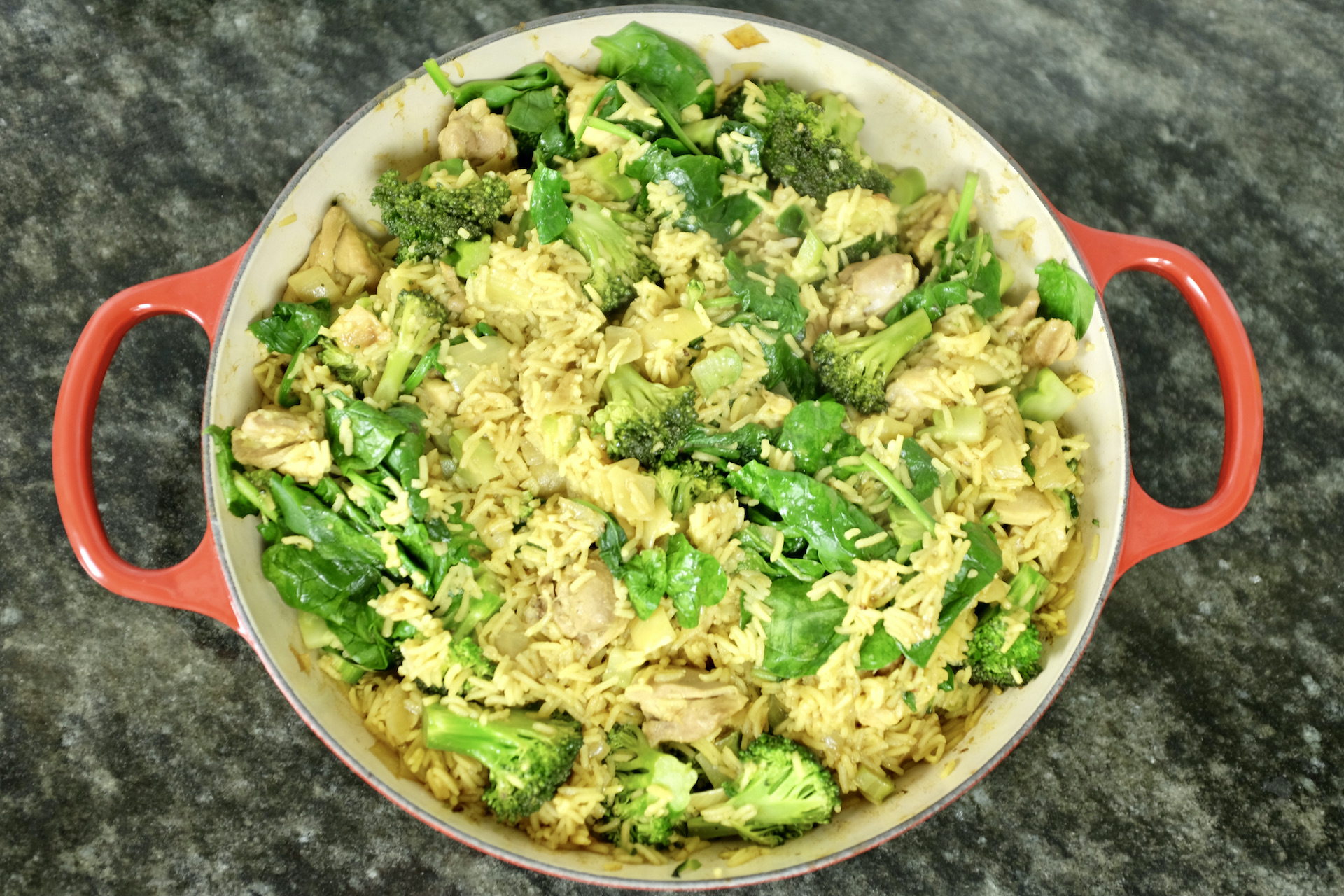 easy made one-pot chicken thigh fillets with curry basmati rice onion garlic broccoli and spinach