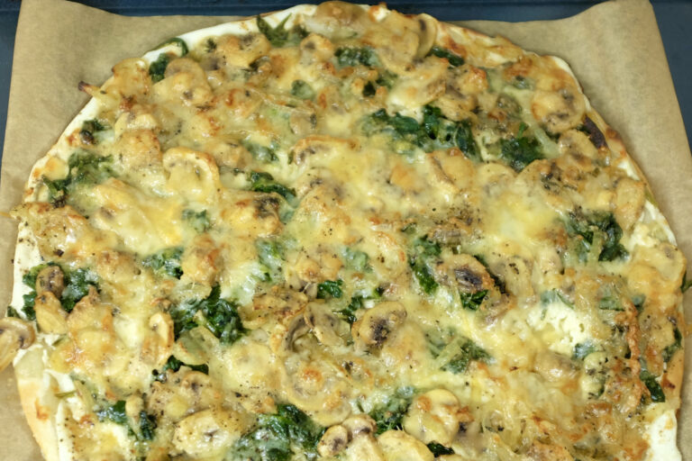 tart with mushroom spinach thyme and emmentaler cheese