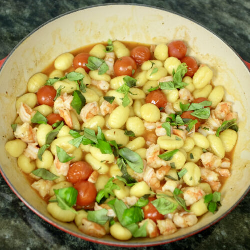 gnocchi with prawns cherry tomatoes and basil leaves