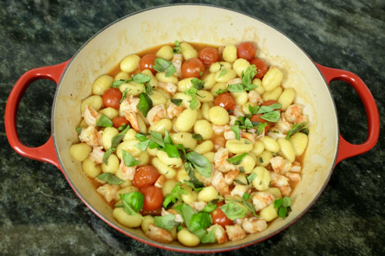 gnocchi with prawns cherry tomatoes and basil leaves