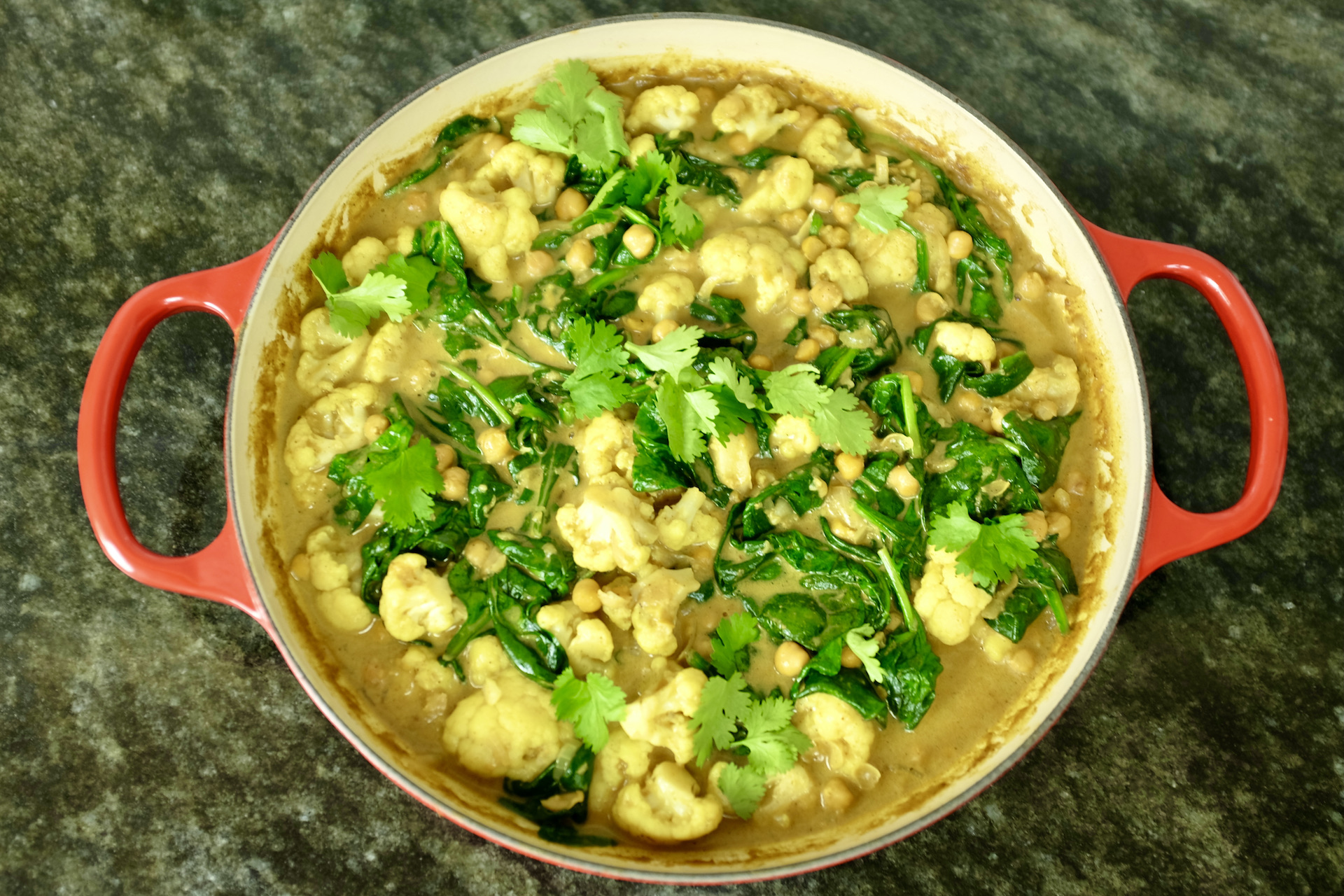 cauliflower chickpea and coconut curry with fresh spinach and ginger