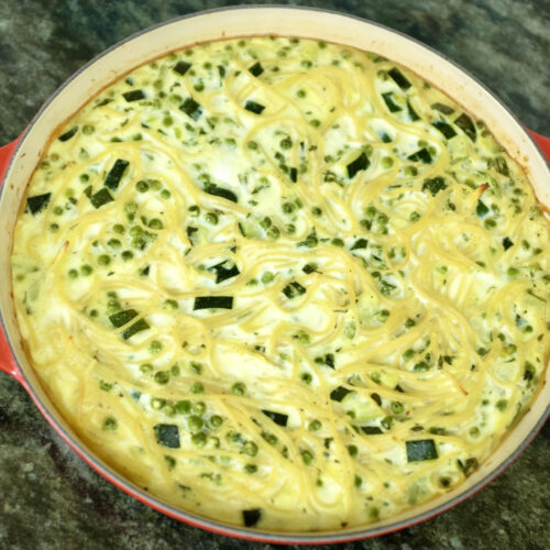 spaghetti frittata with courgette peas garlic mint mozzarella cheese and parmesan cheese