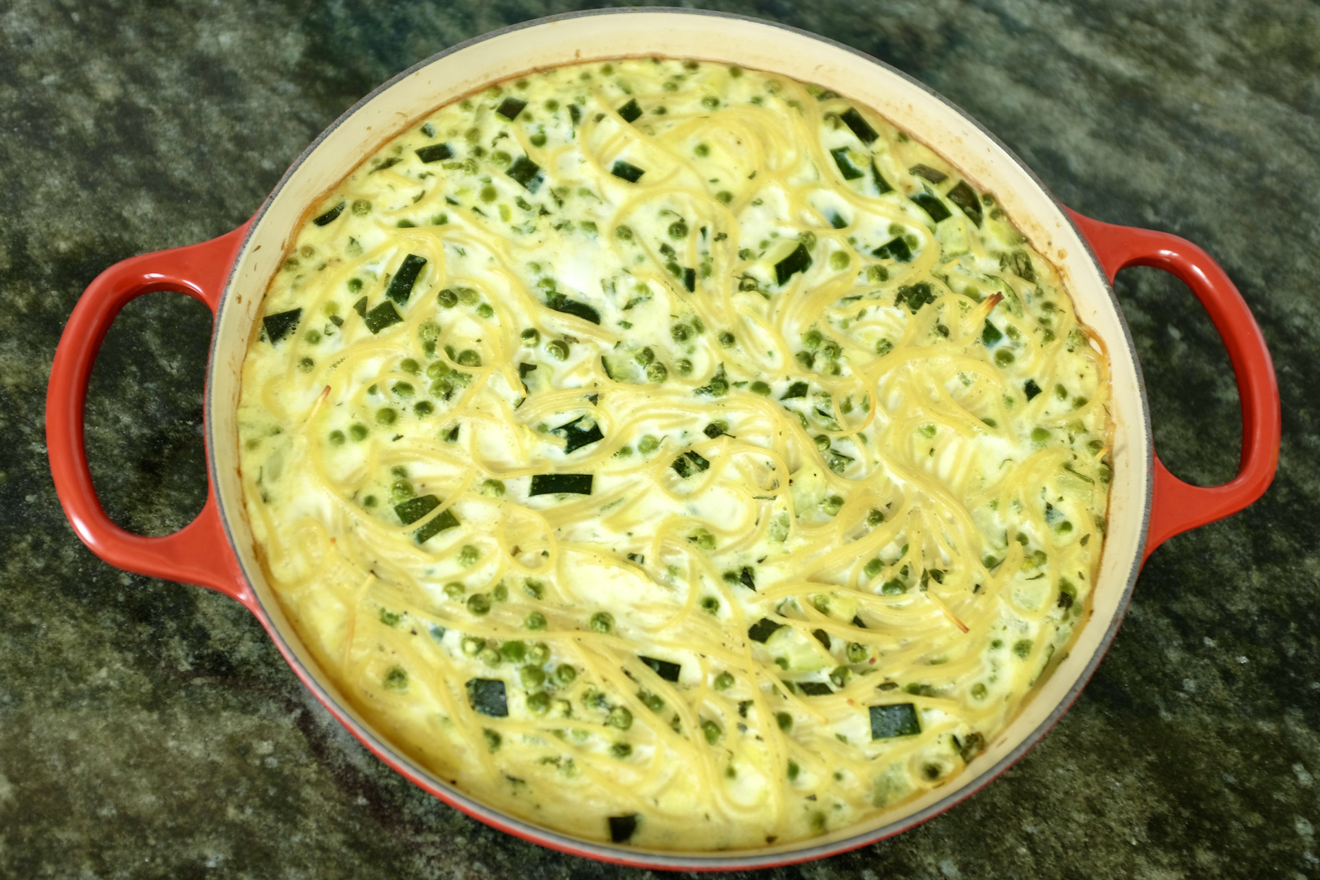 spaghetti frittata with courgette peas garlic mint mozzarella cheese and parmesan cheese