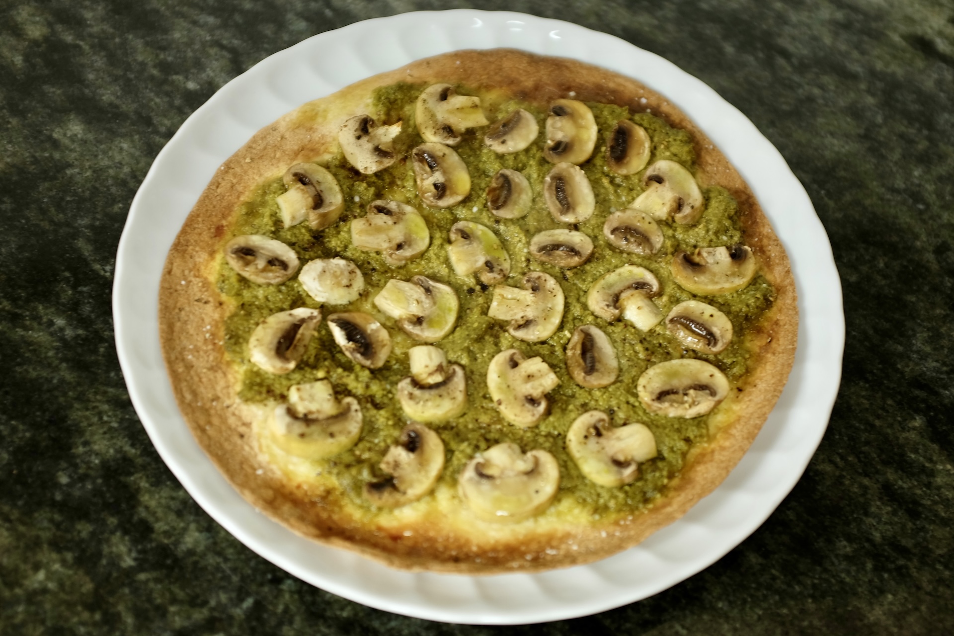 pizza style wrap with pesto verde and white mushrooms