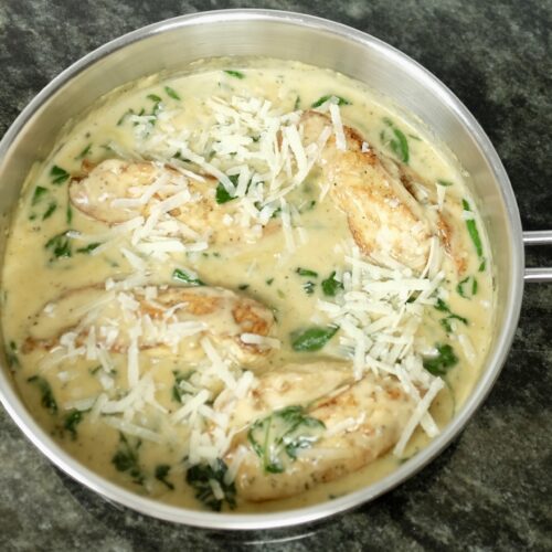 creamy chicken a la florentine with garlic and baby spinach and garnished with parmesan cheese