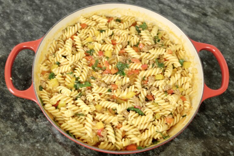 one-pot minced beef pasta with onions, garlic red and yellow bell peppers parsley and cheddar cheese