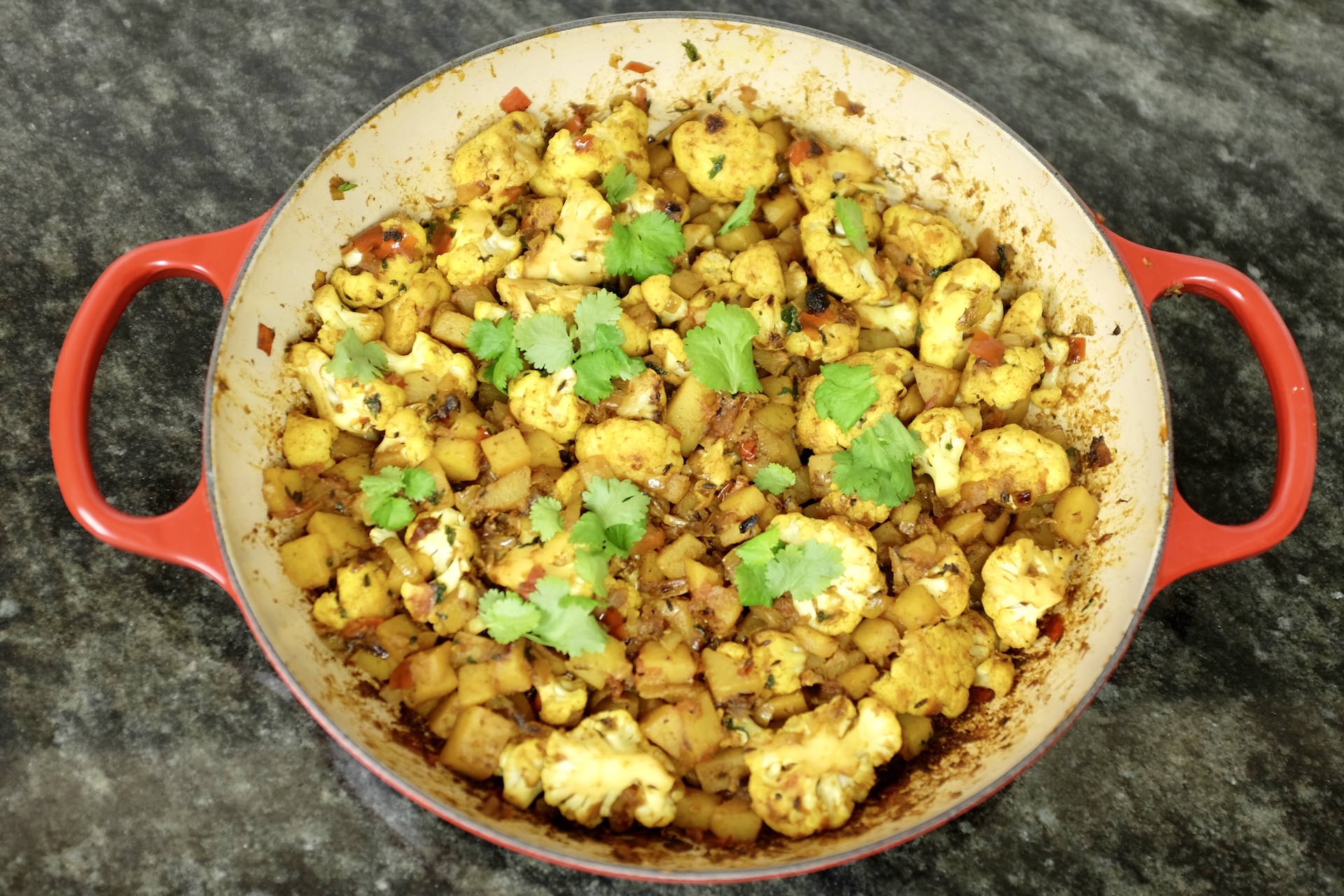 aloo gobi potato and cauliflower curry with onion tomato coriander and lots of spices